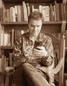man in library with phone